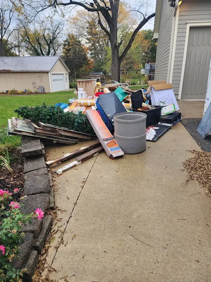 Dumpster being loaded with debris for Demolition Dumpster Rental in Glenville